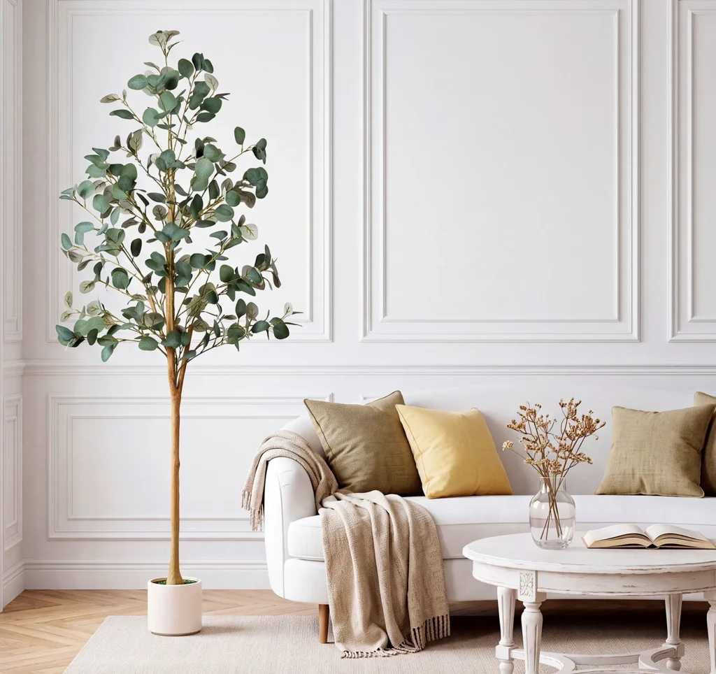 Adorbox artificial eucalyptus tree with rounded green leaves beside a sofa in a neutral living room